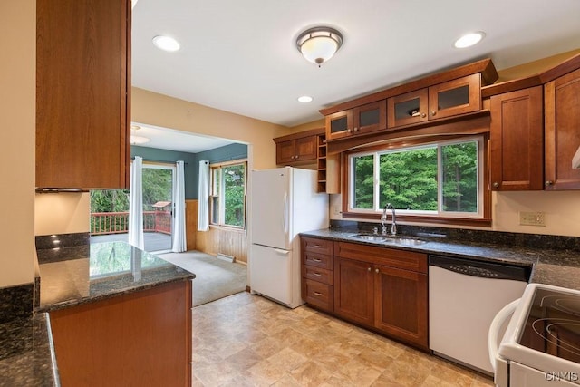 4581 Nelson Rd, Fenner, NY 13035 - kitchen featuring white appliances, brown cabinetry, dark stone counters, healthy amount of natural light, and wainscoting