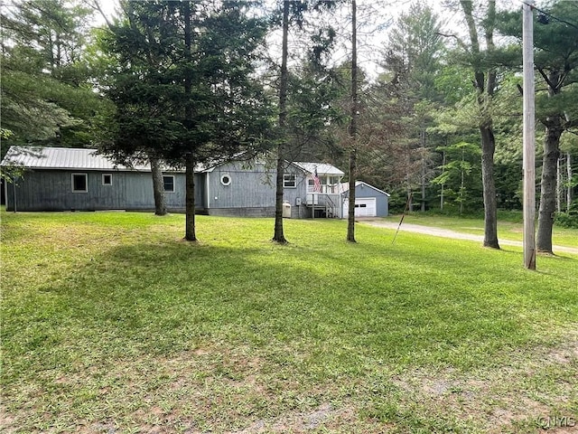 8054 Sand Pond Rd, Greig, NY 13343 - view of grassy yard with an outdoor structure, a detached garage, and driveway