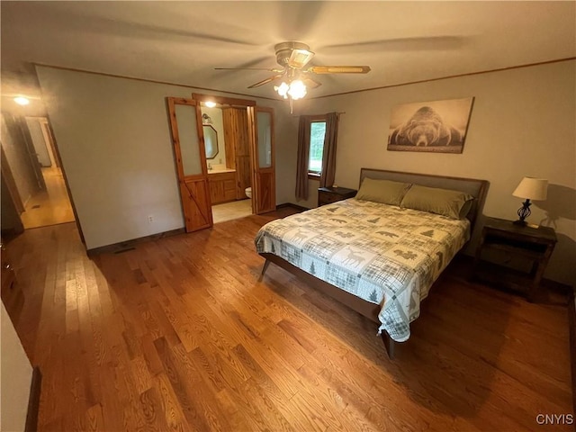 8054 Sand Pond Rd, Greig, NY 13343 - bedroom with wood finished floors, a ceiling fan, and ensuite bath