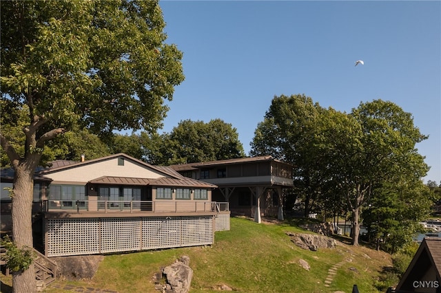 23986 Smith Rd, Alexandria, NY 13607 - rear view of property with a yard, a standing seam roof, a metal roof, and a sunroom