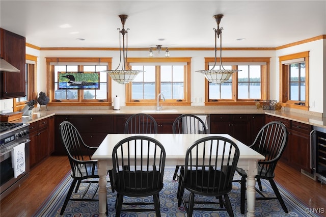 23986 Smith Rd, Alexandria, NY 13607 - dining room featuring dark wood-type flooring, wine cooler, and ornamental molding