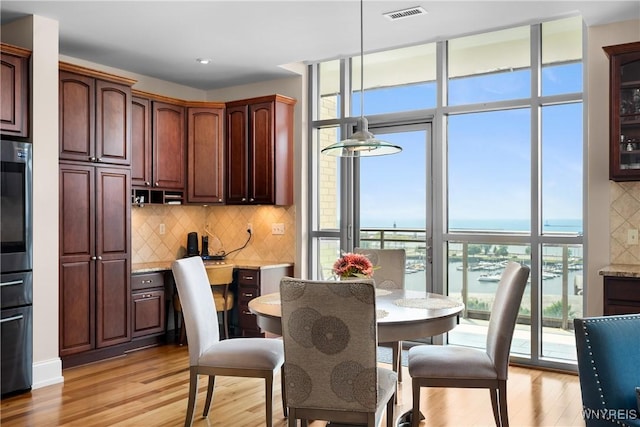 132 Lakefront Blvd Unit 804, Buffalo, NY 14202 - dining room featuring light wood-style flooring, healthy amount of natural light, built in study area, a water view, and recessed lighting