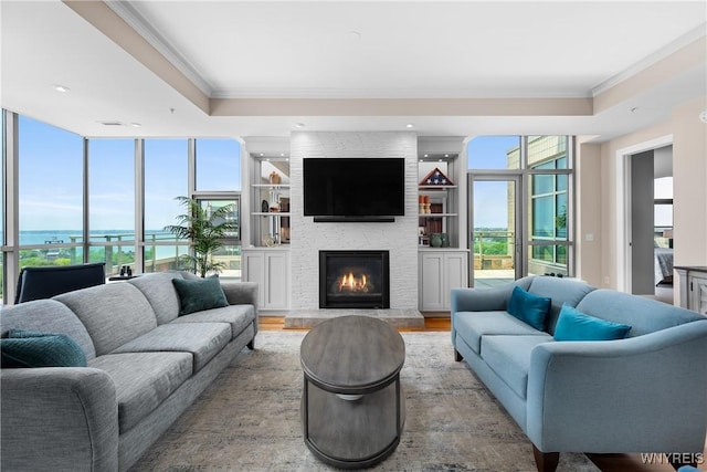 132 Lakefront Blvd Unit 804, Buffalo, NY 14202 - living room with crown molding, a stone fireplace, and wood finished floors
