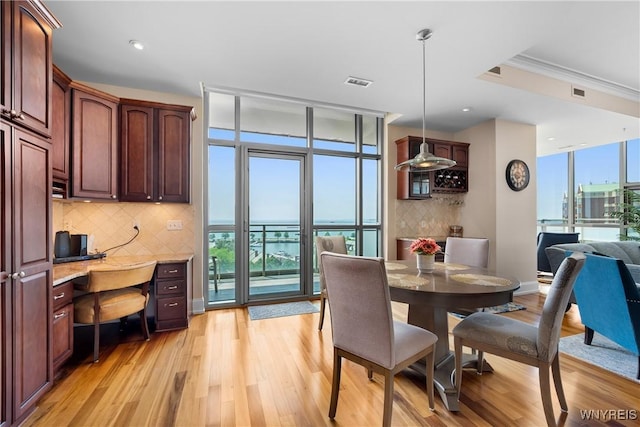 132 Lakefront Blvd Unit 804, Buffalo, NY 14202 - dining room featuring light wood-style floors, ornamental molding, built in study area, and recessed lighting