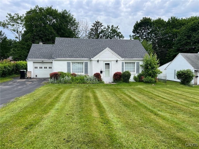 40 Beechwood Rd, New Hartford, NY 13413 - view of front of house featuring asphalt driveway, a garage, a front yard, roof with shingles, and stucco siding