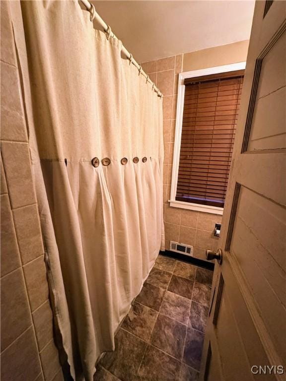 373 S Collingwood Ave, Syracuse, NY 13206 - full bathroom with tile walls, curtained shower, and stone finish floors