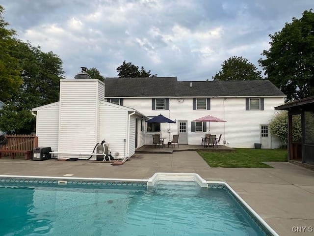 60 Cambridge Rd, Whitestown, NY 13492 - rear view of house featuring a patio, an outdoor pool, and a chimney