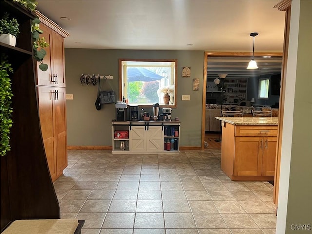 60 Cambridge Rd, Whitestown, NY 13492 - kitchen with plenty of natural light, light stone counters, hanging light fixtures, and light tile patterned floors