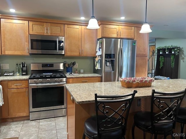 60 Cambridge Rd, Whitestown, NY 13492 - kitchen featuring appliances with stainless steel finishes, a breakfast bar, brown cabinetry, hanging light fixtures, and recessed lighting