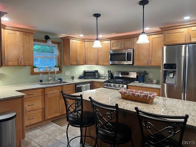 60 Cambridge Rd, Whitestown, NY 13492 - kitchen with stainless steel appliances, a kitchen breakfast bar, decorative light fixtures, light stone counters, and brown cabinets