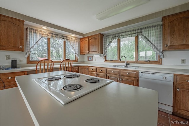 4724 Wilson Burt Rd, Wilson, NY 14172 - kitchen with dishwasher, brown cabinetry, light countertops, electric cooktop, and a center island