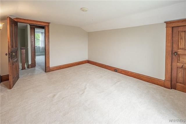 4724 Wilson Burt Rd, Wilson, NY 14172 - empty room featuring light colored carpet, lofted ceiling, and a smoke detector