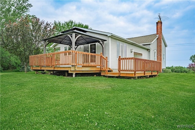 4724 Wilson Burt Rd, Wilson, NY 14172 - rear view of property with a wooden deck, a lawn, and a chimney