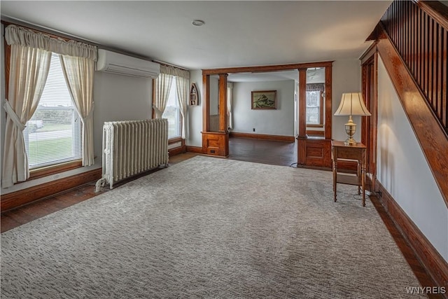 4724 Wilson Burt Rd, Wilson, NY 14172 - unfurnished room with radiator heating unit, a wall mounted AC, and plenty of natural light