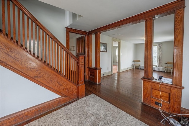 4724 Wilson Burt Rd, Wilson, NY 14172 - staircase with ornate columns, wood finished floors, and radiator heating unit