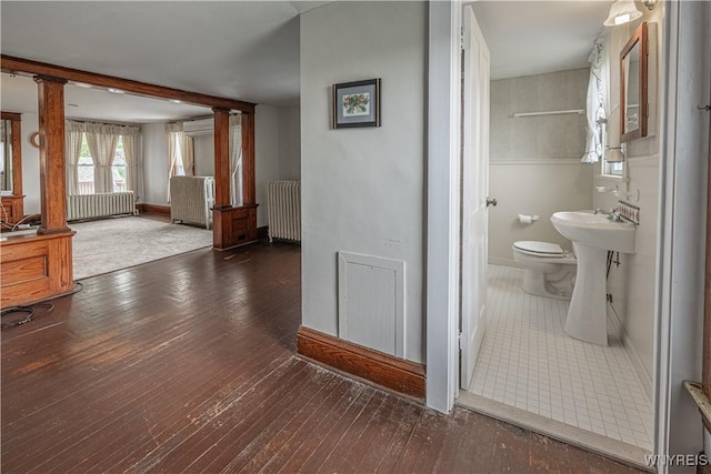 4724 Wilson Burt Rd, Wilson, NY 14172 - bathroom featuring radiator heating unit, ornate columns, and wood-type flooring