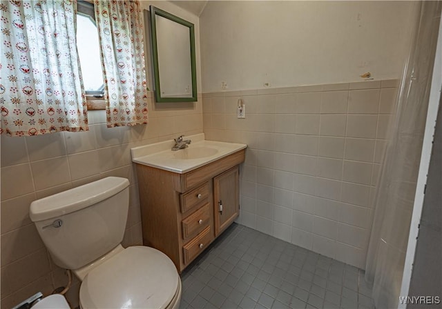 4724 Wilson Burt Rd, Wilson, NY 14172 - full bathroom featuring tile walls, vanity, tile patterned floors, and wainscoting