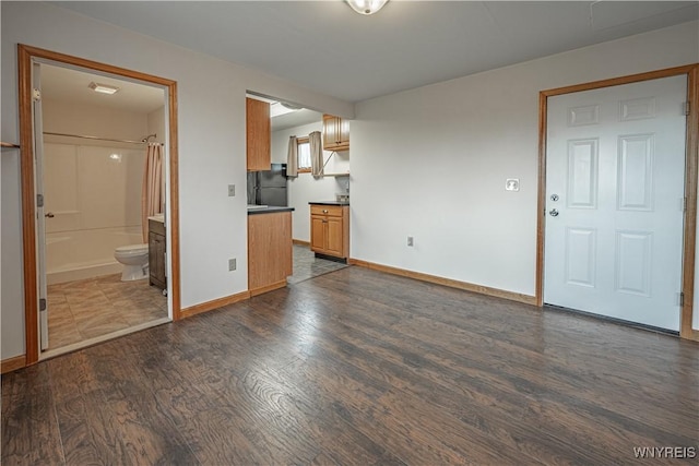 4724 Wilson Burt Rd, Wilson, NY 14172 - unfurnished living room featuring dark wood-style flooring and baseboards