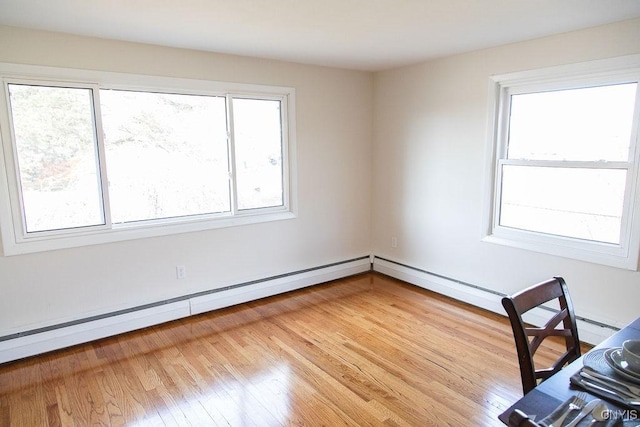 4114 Wetzel Rd, Clay, NY 13090 - unfurnished office with plenty of natural light, a baseboard radiator, and light wood-style flooring