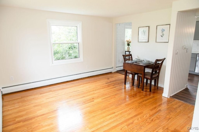 4114 Wetzel Rd, Clay, NY 13090 - dining area with a baseboard radiator and light wood-style flooring