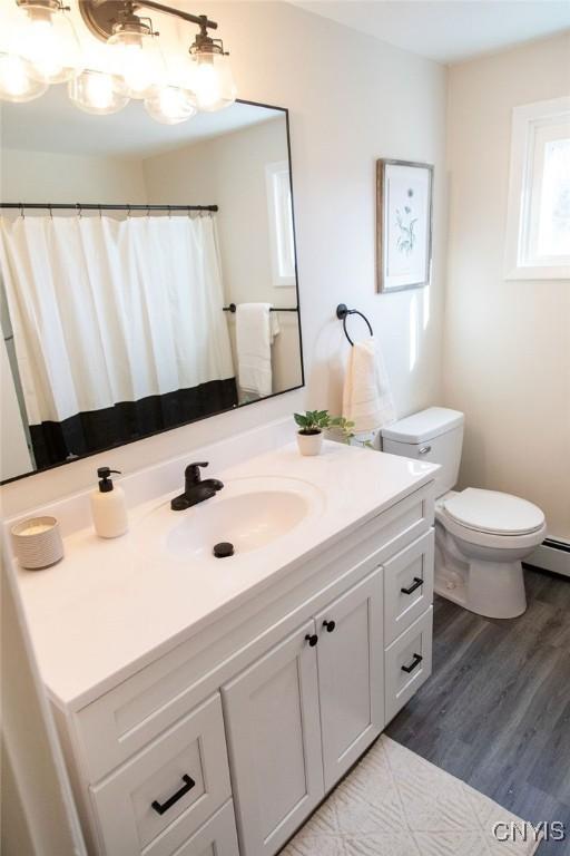 4114 Wetzel Rd, Clay, NY 13090 - full bath with vanity and wood finished floors