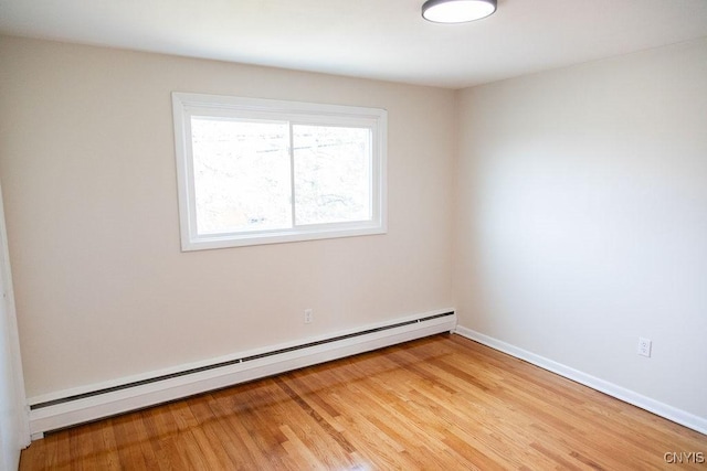 4114 Wetzel Rd, Clay, NY 13090 - spare room featuring a baseboard heating unit and light wood-style floors
