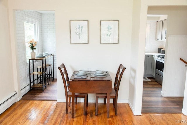 4114 Wetzel Rd, Clay, NY 13090 - dining space with light wood finished floors and baseboard heating