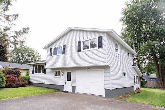 4114 Wetzel Rd, Clay, NY 13090 - tri-level home featuring a front lawn, an attached garage, and asphalt driveway