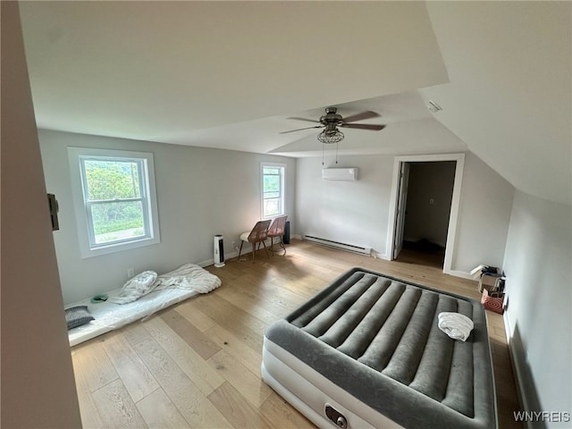 876 Hittown Rd, Caton, NY 14871 - bedroom featuring a baseboard heating unit, a wall mounted AC, wood finished floors, and ceiling fan
