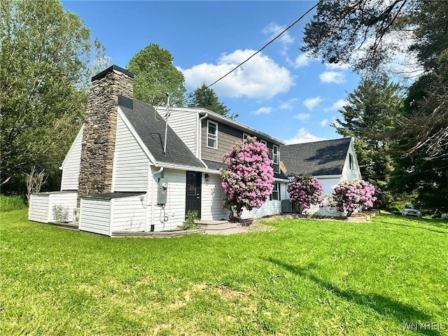 876 Hittown Rd, Caton, NY 14871 - view of front of home with a front yard, a chimney, and roof with shingles