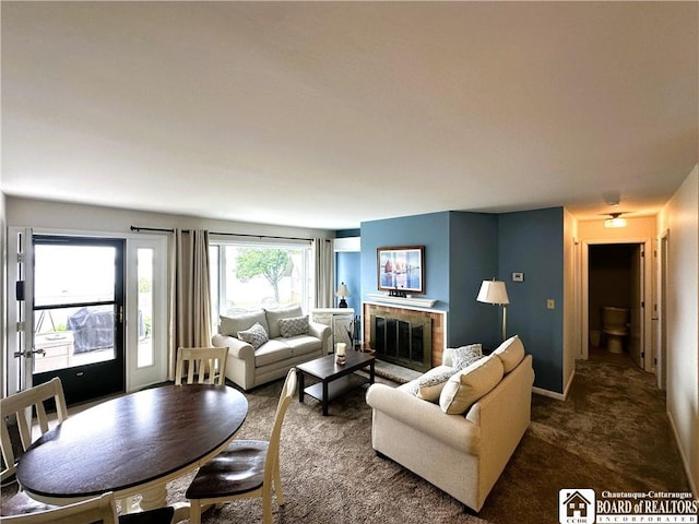 23 Seneca Dr, Chautauqua, NY 14728 - living area with dark colored carpet and a fireplace