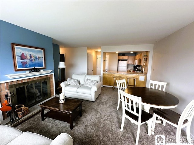 23 Seneca Dr, Chautauqua, NY 14728 - carpeted living area with a fireplace