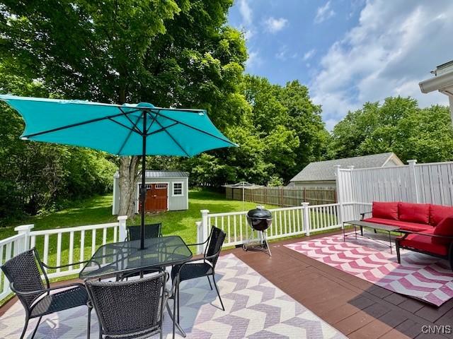 4079 Onondaga Blvd, Onondaga, NY 13031 - view of patio featuring a storage unit, outdoor lounge area, outdoor dining area, a wooden deck, and area for grilling