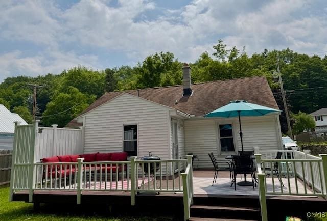4079 Onondaga Blvd, Onondaga, NY 13031 - rear view of house with outdoor dining area, a wooden deck, a chimney, and an outdoor living space