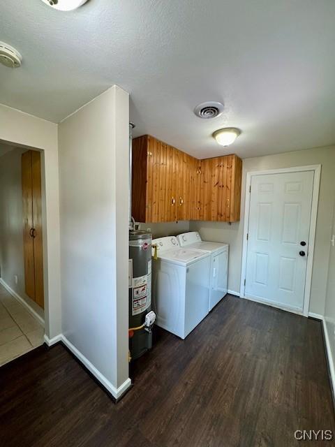 4079 Onondaga Blvd, Onondaga, NY 13031 - washroom featuring cabinet space, gas water heater, washer and dryer, and dark wood-style flooring