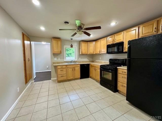 4079 Onondaga Blvd, Onondaga, NY 13031 - kitchen featuring black appliances, light brown cabinetry, light countertops, ceiling fan, and light tile patterned flooring