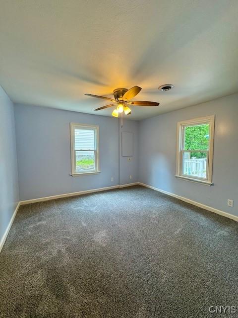 4079 Onondaga Blvd, Onondaga, NY 13031 - unfurnished room featuring a ceiling fan and dark colored carpet