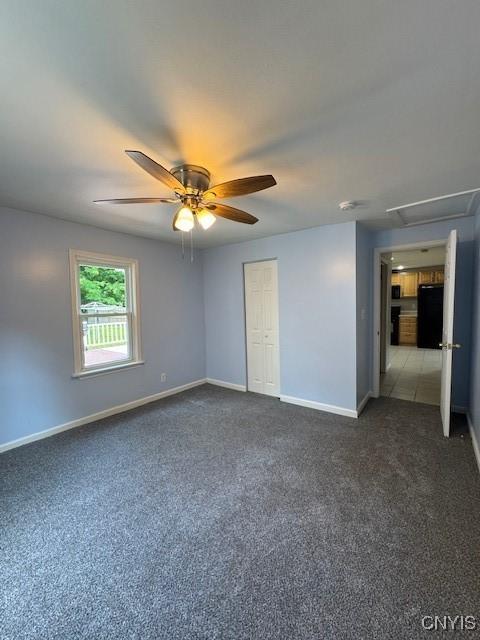 4079 Onondaga Blvd, Onondaga, NY 13031 - unfurnished bedroom featuring dark colored carpet, a ceiling fan, and a closet