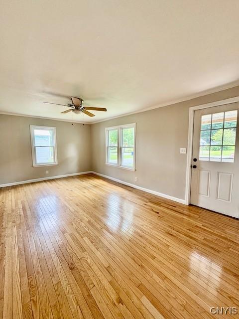 4079 Onondaga Blvd, Onondaga, NY 13031 - unfurnished room with light wood-style floors, plenty of natural light, ornamental molding, and ceiling fan