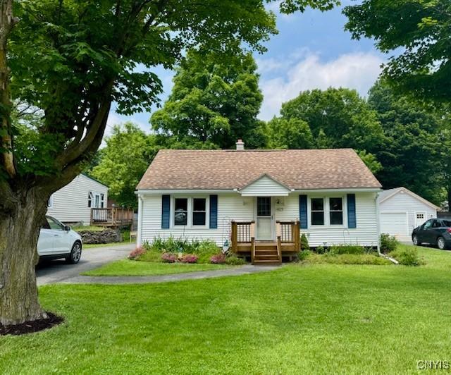 4079 Onondaga Blvd, Onondaga, NY 13031 - bungalow-style home with a front yard, a chimney, a garage, and driveway