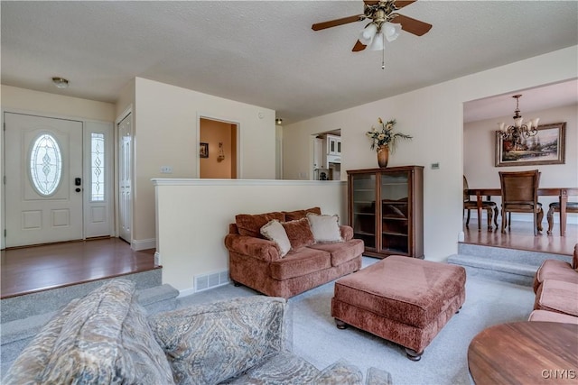 40 Phyllis Ln, Hastings, NY 13076 - living area with carpet floors, a chandelier, a ceiling fan, and a textured ceiling