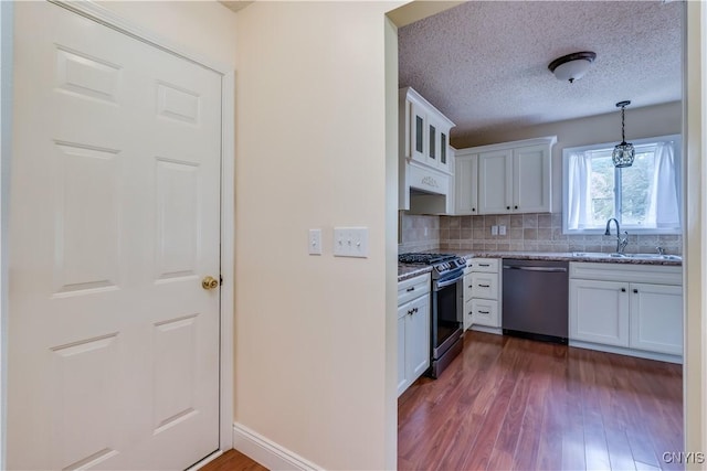 40 Phyllis Ln, Hastings, NY 13076 - kitchen with stainless steel appliances, white cabinets, dark wood-type flooring, light stone counters, and a textured ceiling