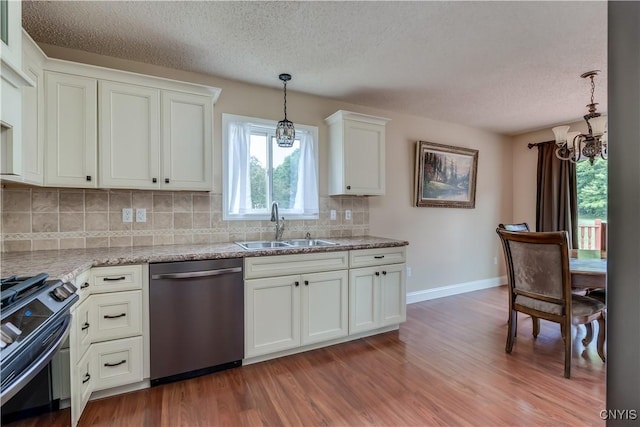 40 Phyllis Ln, Hastings, NY 13076 - kitchen with stainless steel dishwasher, gas range oven, a textured ceiling, a chandelier, and decorative backsplash