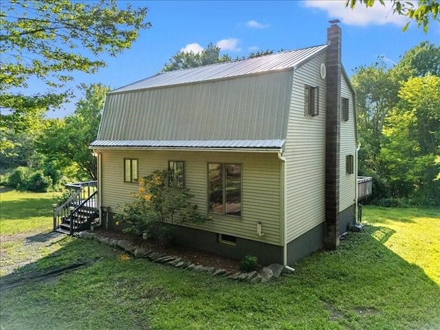 1135 Ridge Rd, Hamden, NY 13782 - view of home's exterior featuring a chimney, a yard, and a metal roof