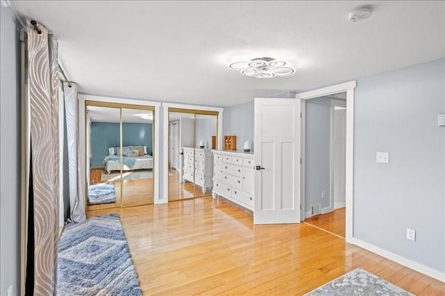 1135 Ridge Rd, Hamden, NY 13782 - bedroom with light wood finished floors, multiple closets, and french doors