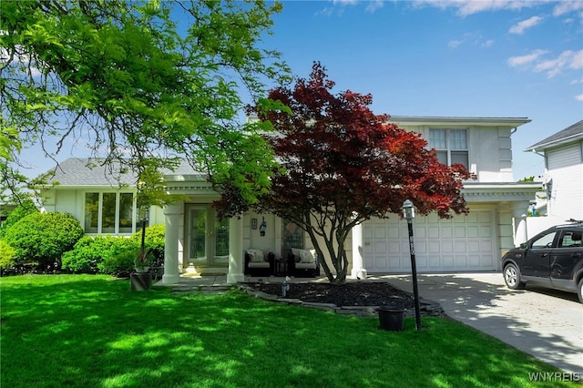 330 Hunters Ln, Amherst, NY 14221 - obstructed view of property with concrete driveway, a front yard, an attached garage, and stucco siding