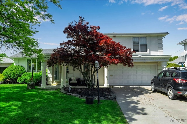 330 Hunters Ln, Amherst, NY 14221 - obstructed view of property with driveway, stucco siding, a front yard, and an attached garage