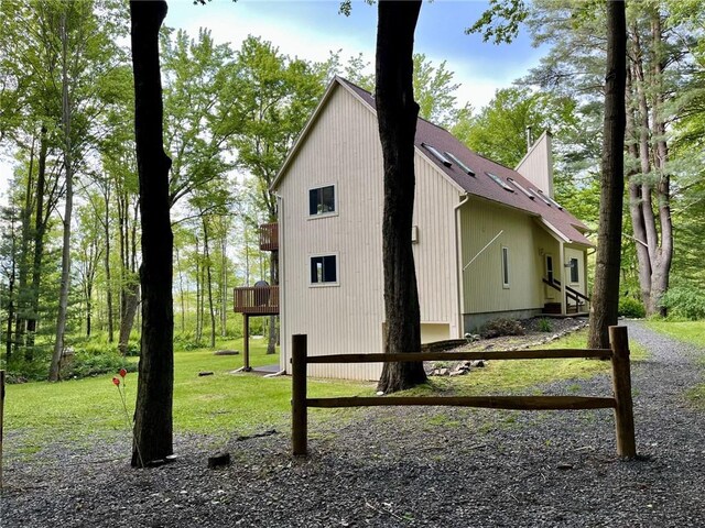 735 Howell Rd, Conquest, NY 13140 - view of side of home with a lawn and a wooden deck