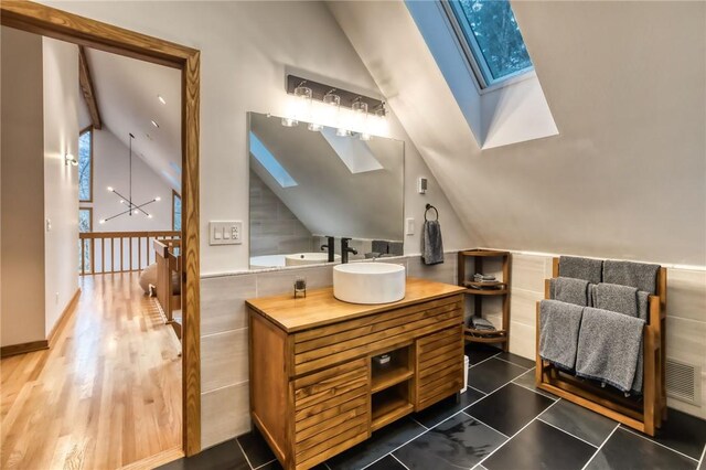 735 Howell Rd, Conquest, NY 13140 - bathroom with a skylight, vaulted ceiling, and vanity