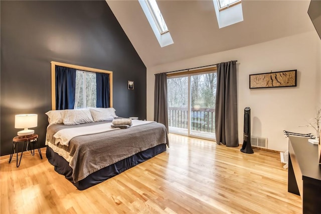 735 Howell Rd, Conquest, NY 13140 - bedroom with high vaulted ceiling, a skylight, access to exterior, and wood finished floors